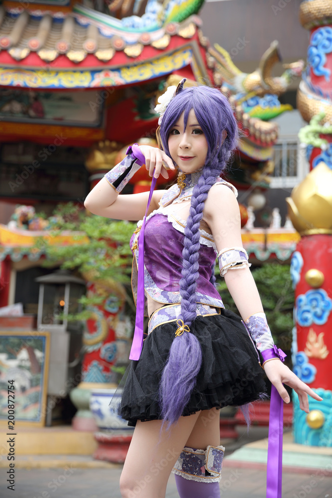 Portrait of asian young woman dancing with purple Chinese dress cosplay with temple