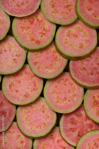Rounded slices of pink guava close up, pattern