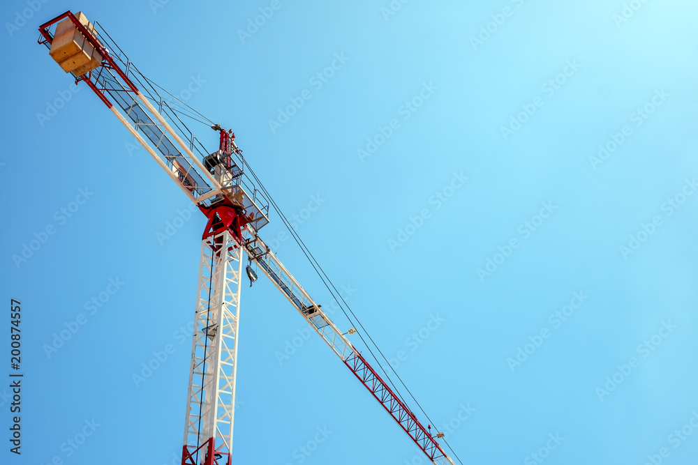 crane during construction of a new building on blue sky crane during construction of a new building on blue sky