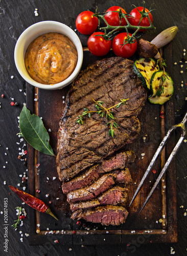 Delicious beef rump steak on wooden table