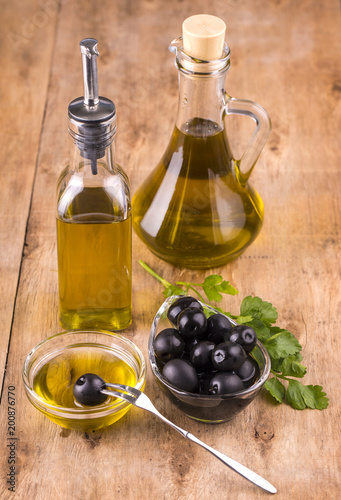 Olives and Healthy Olive oil bottles and cup with parsley