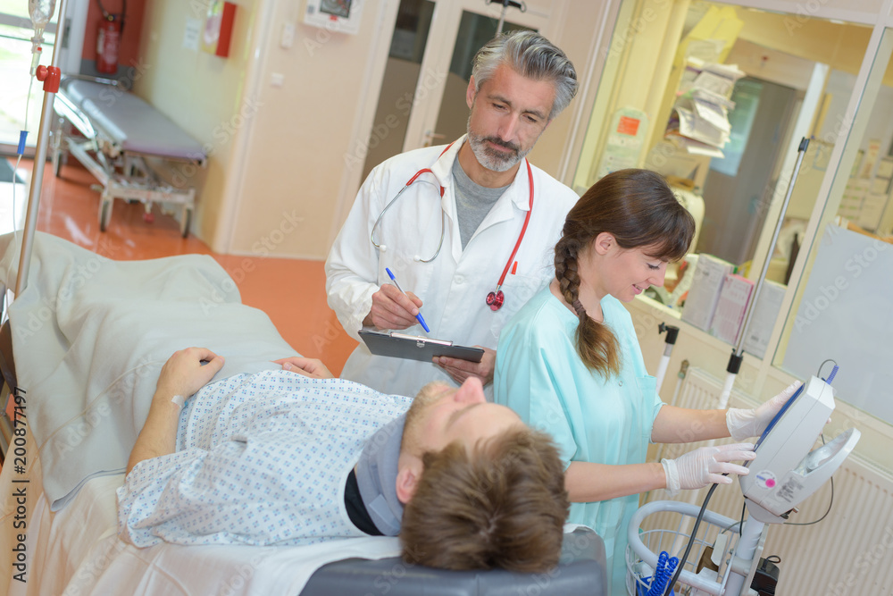 doctor showing positive test on clipboard to sick man doctor showing positive test on clipboard to sick man