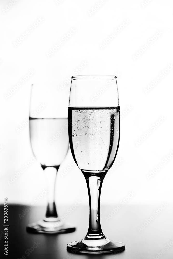 monochrome photo of champagne on white table on white background monochrome photo of champagne on white table on white background