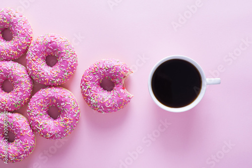 Foto Pink and white donuts with celebration item on pink background