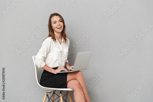 Young business woman using laptop computer.