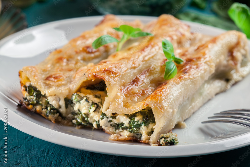 Portion of cannelloni stuffed with spinach Portion of cannelloni stuffed with spinach