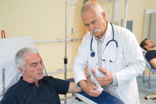 doctor wrapping the hand of the patient
