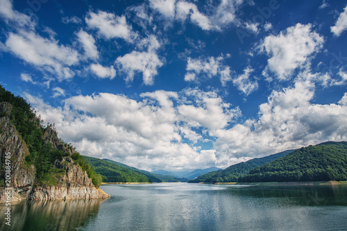 Mountain lake. Scenic landscape. Beautiful blue sky with clouds