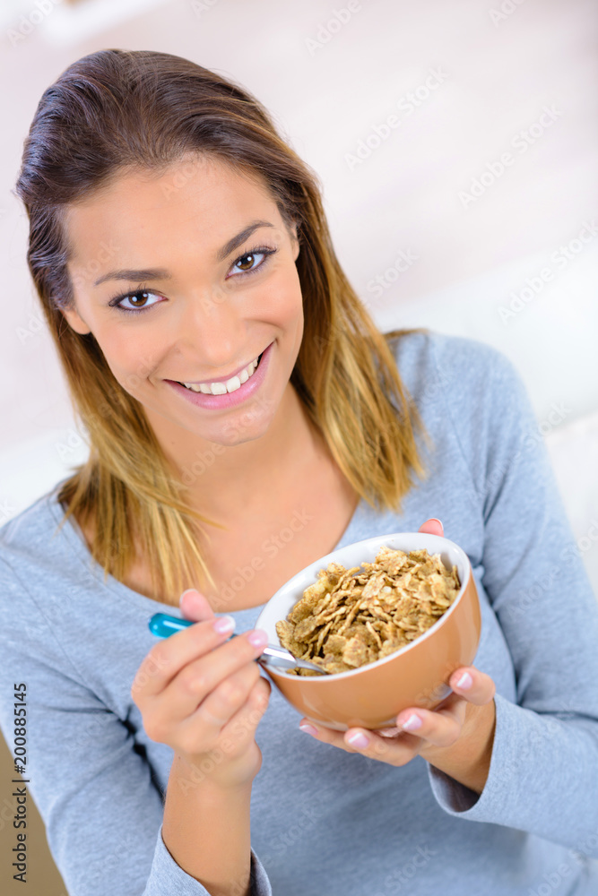 Woman eating cereal for breakfast Woman eating cereal for breakfast
