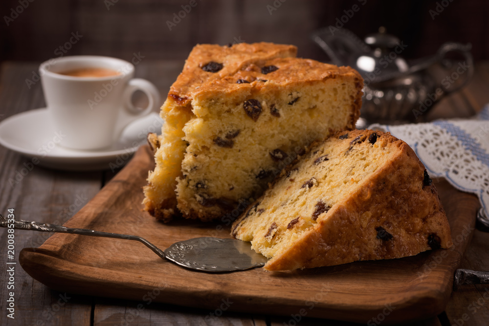 cup of coffee and slices of home made cake with raisins on wooden plate cup of coffee and slices of home made cake with raisins on wooden plate