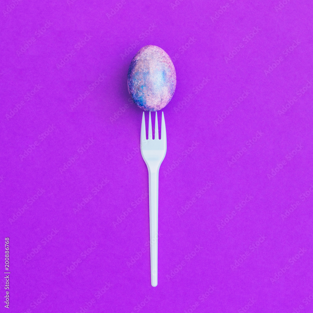 crazy magic eggs with cosmic pattern on purple background with plastic fork. fabulous dragon eggs concept. minimal and surreal artwork. flat lay crazy magic eggs with cosmic pattern on purple background with plastic fork. fabulous dragon eggs concept. minimal and surreal artwork. flat lay