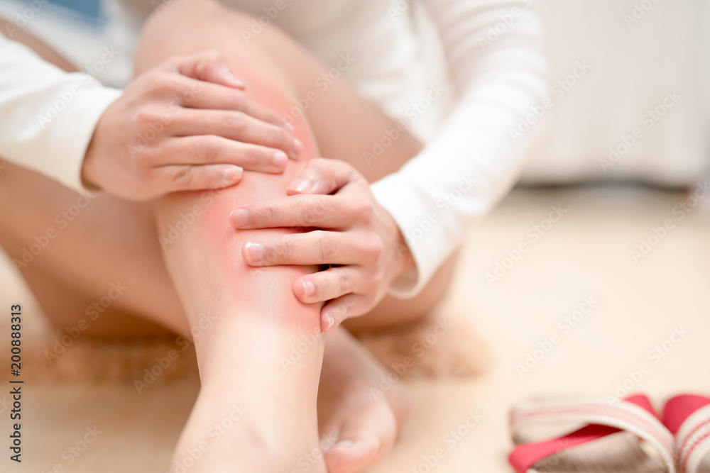 leg ankle injury painful women touching the leg painful with red highlight on injure. healthcare and medical concept