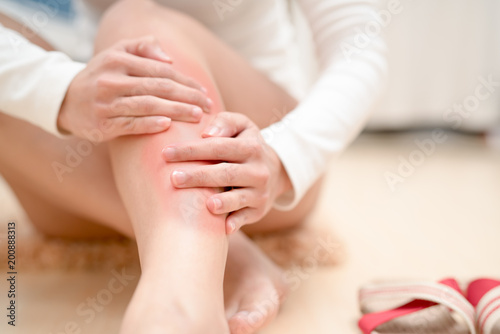 leg ankle injury painful women touching the leg painful with red highlight on injure. healthcare and medical concept