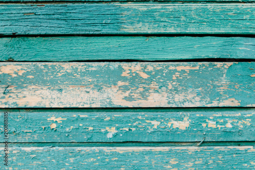Green background of weathered painted wooden plank