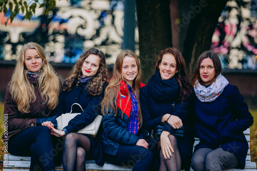 Female students strolling in the Park in autumn