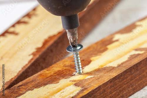 screw screwed into a wooden bar