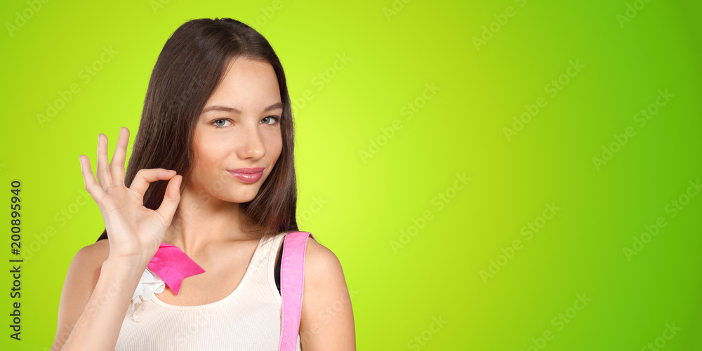 Positive young woman expressing happiness and showing OK Positive young woman expressing happiness and showing OK