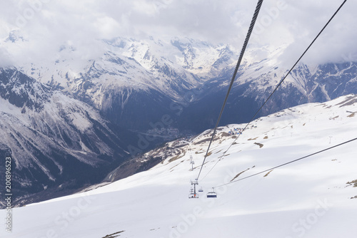 cable car on snow-covered mountain slopes, mountain valley, Caucasus © Elena