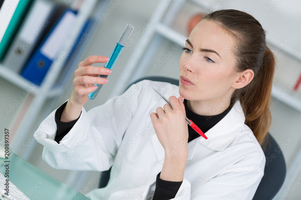 female lab chemist full test tube with long pipette female lab chemist full test tube with long pipette