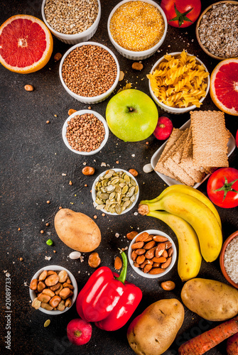 Fototapeta Naklejka Na Ścianę i Meble -  Diet food background concept, healthy carbohydrates (carbs) products - fruits, vegetables, cereals, nuts, beans, dark blue concrete background top view copy space