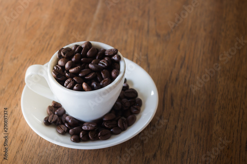 Coffee Cup or Coffee Beans on wooden table