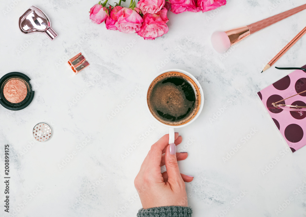 Woman's hand holding coffee on the table Woman's hand holding coffee on the table