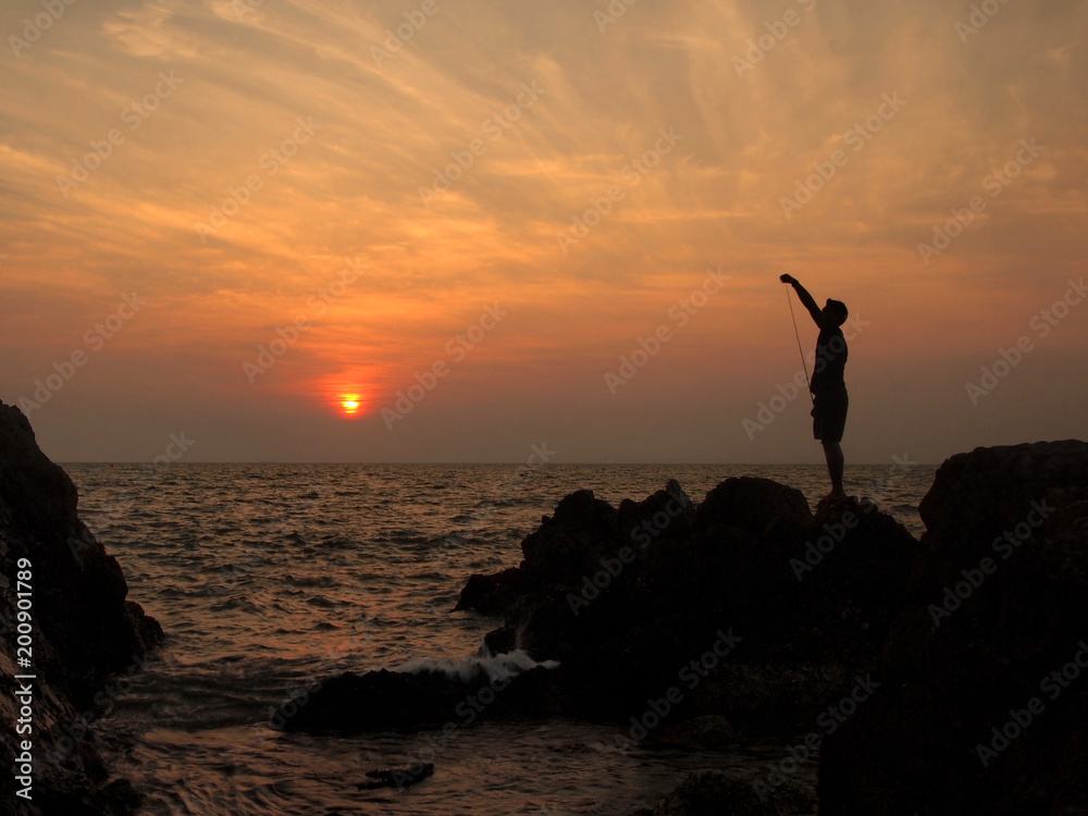 Fototapeta premium fishermen silhouette at sunset