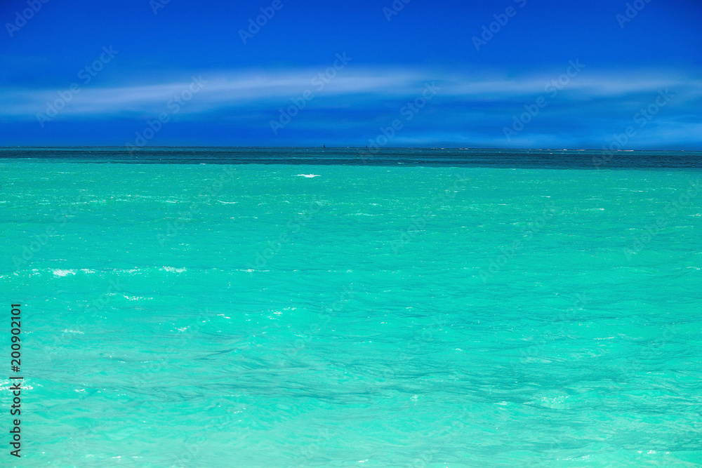 Panorama of the ocean with beautiful water colors and blue sky