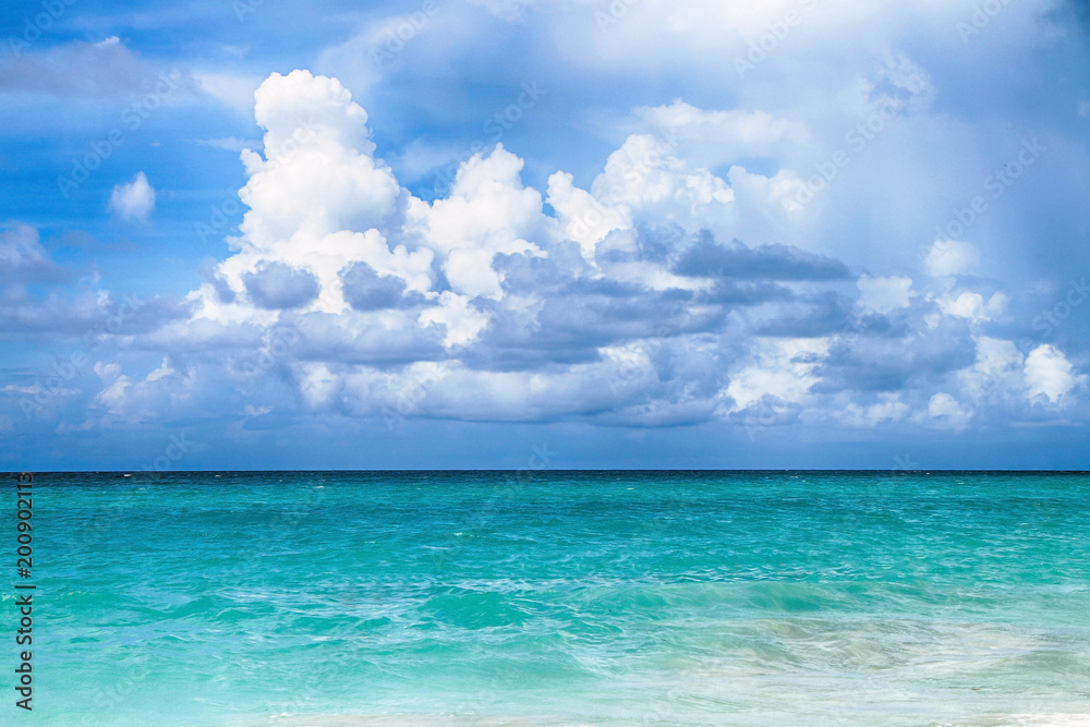 Panorama of the ocean with beautiful water colors and blue sky