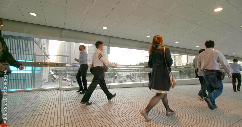 Fototapeta premium People walking in pedestrian bridge