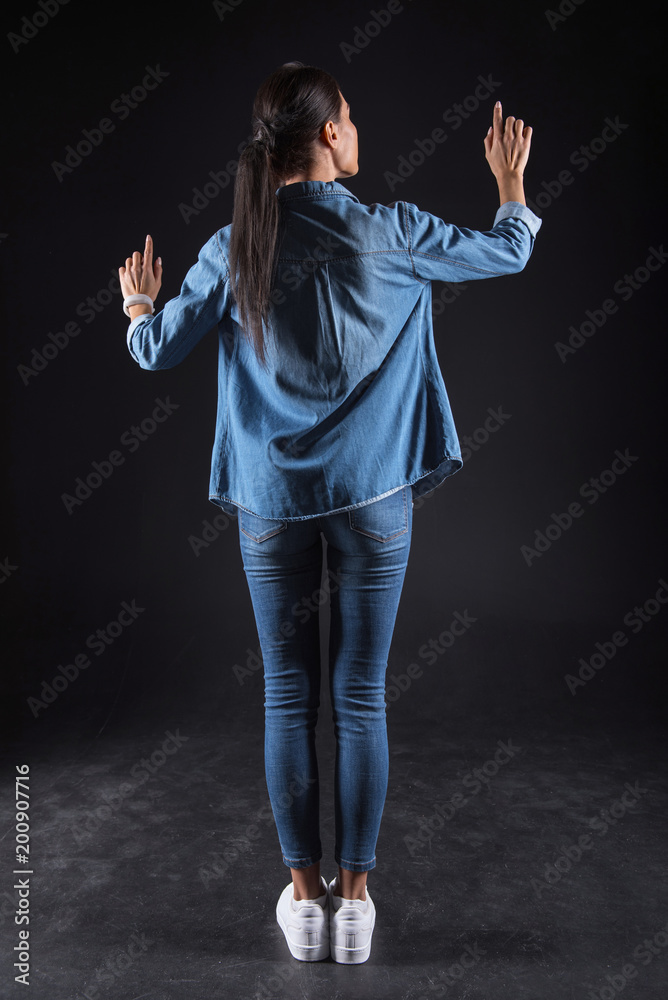 Modern generation. Attractive pleasant nice woman standing and looking at the sensory screen while using modern technology Modern generation. Attractive pleasant nice woman standing and looking at the sensory screen while using modern technology