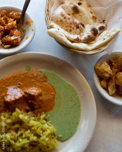Indian chicken masala, cabbage, naan, onion fritters and carrot almond dessert