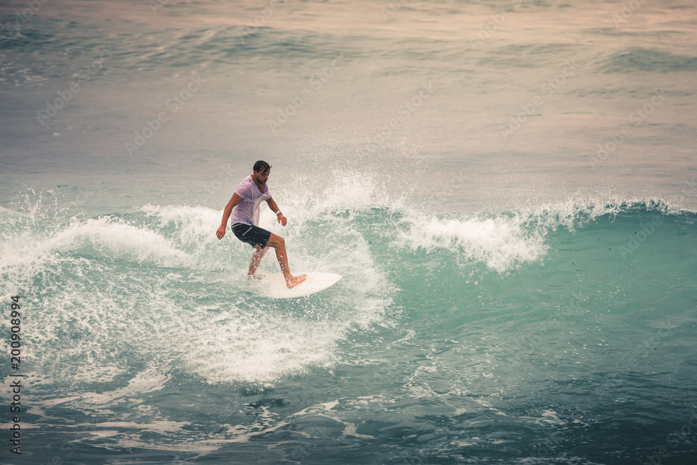 Surfer on Blue Ocean Wave, Bali, Indonesia. Riding in tube. Surfer on Blue Ocean Wave, Bali, Indonesia. Riding in tube.