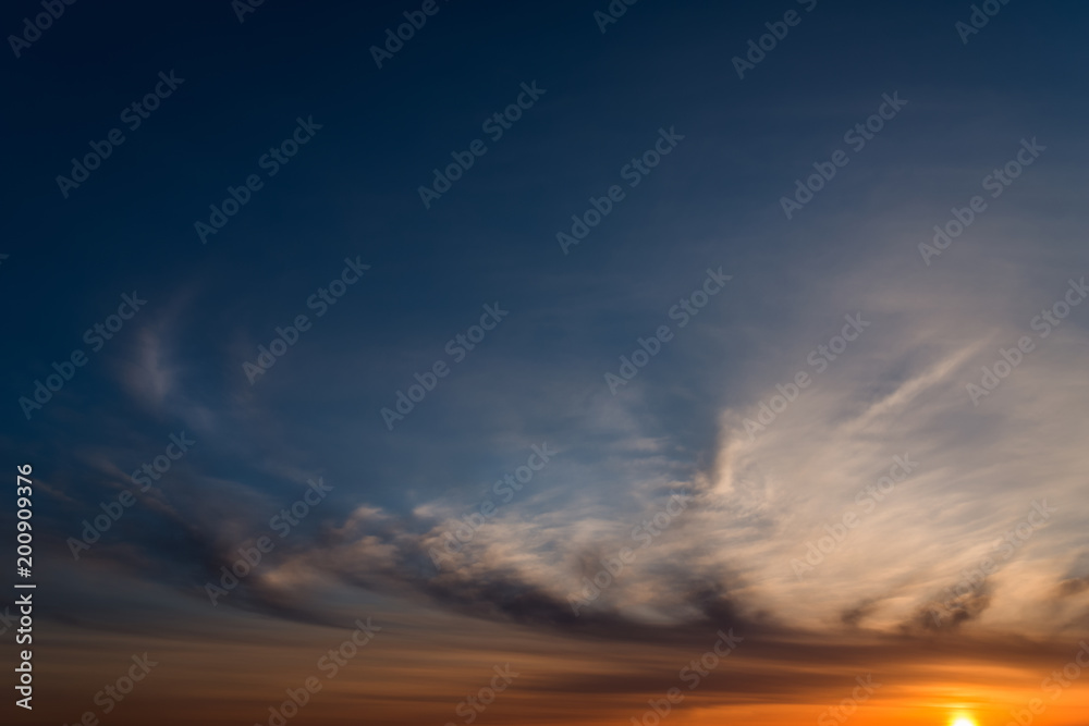 Fototapeta premium Dramatic sunset sky with orange colored clouds.
