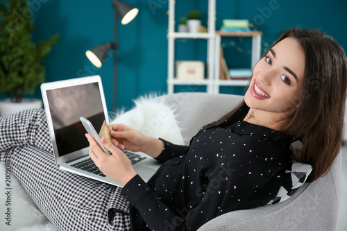 Young woman shopping online...