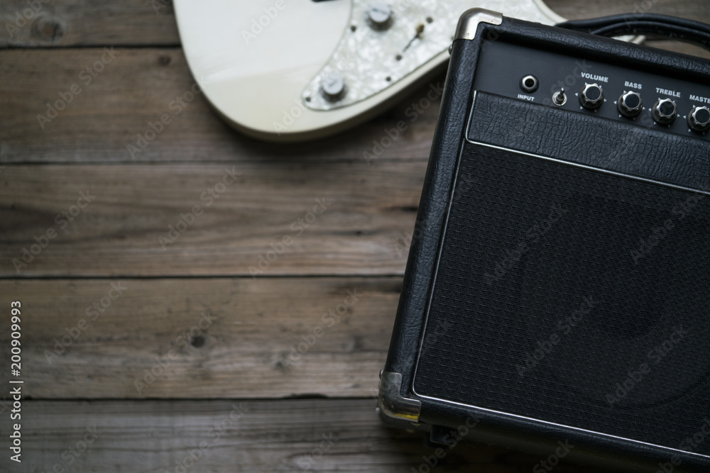 Obraz premium Guitar amplifier and a electric guitar on wood table
