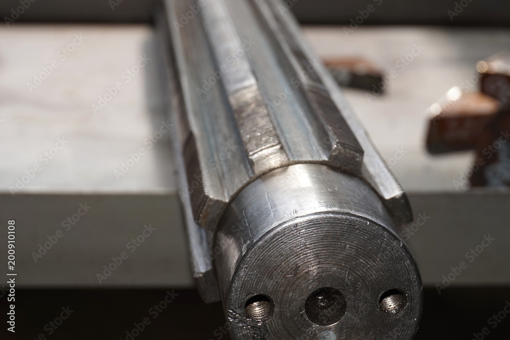 Splined shaft after disassembly of teeth lies on the rack in the