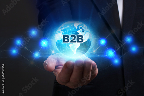 Business, Technology, Internet and network concept. Young businessman working on a virtual screen of the future and sees the inscription: B2B