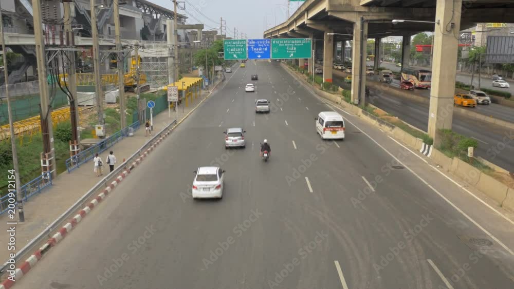 View of Vibhavadi Rangsit Road and the traffic in Bangkok many cars are on the roads and buildings are along the road. View of Vibhavadi Rangsit Road and the traffic in Bangkok many cars are on the roads and buildings are along the road.