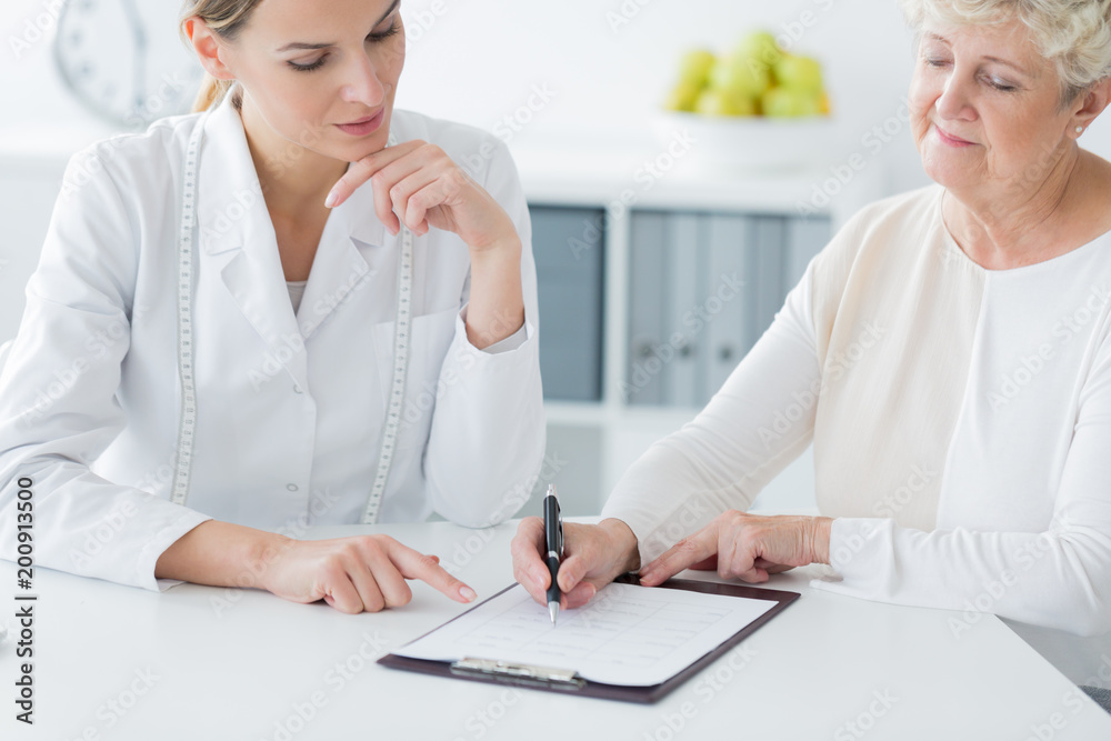Elderly woman choosing diet plan Elderly woman choosing diet plan