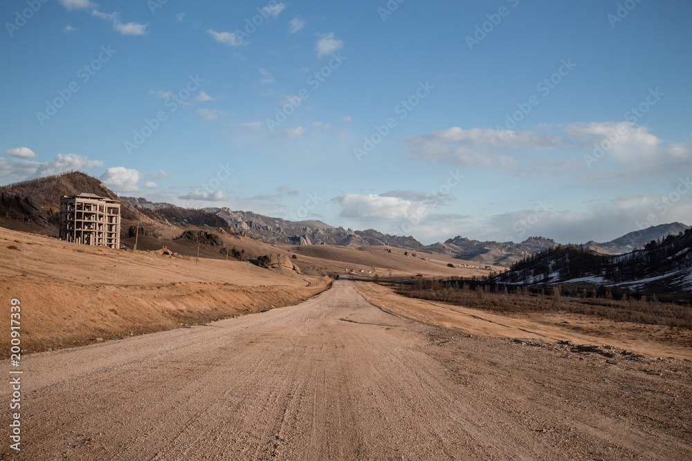 Sand road track outside country with mountain and blue sky