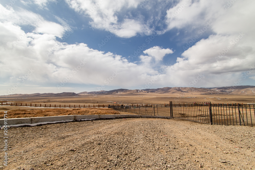 View of land, mountain and cloudy sky outside the city of Ulaanbaatar, Mongolia