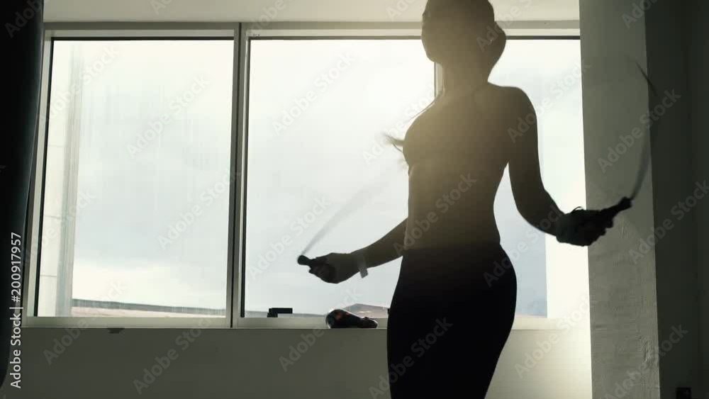 Woman doing jump rope workout at the gym
