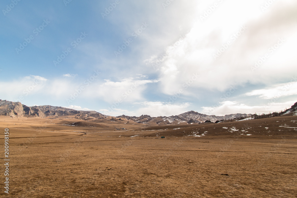View of land, mountain and cloudy sky outside the city of Ulaanbaatar, Mongolia