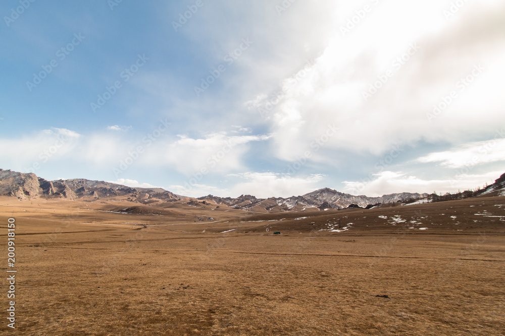 Fototapeta premium View of land, mountain and cloudy sky outside the city of Ulaanbaatar, Mongolia
