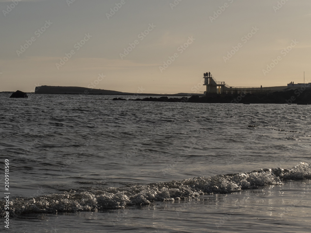 Black rock at dusk, in Salthill, Galway city, Galway, Ireland.
