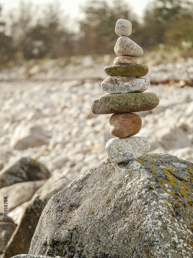Tower made of rocks on a big stone, concept balance, patience, art, craft Tower made of rocks on a big stone, concept balance, patience, art, craft
