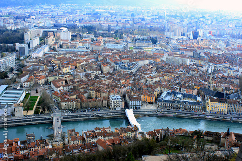 Top aerial view on the city of Grenoble, France with red roofs, river 