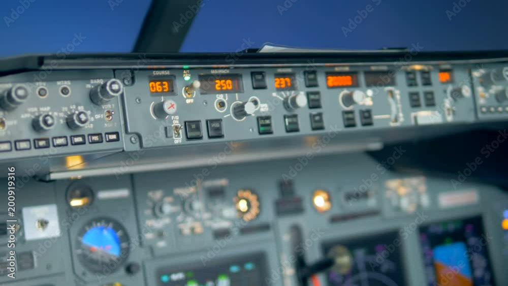 A pilot checks the dashboard, close up. A pilot checks the dashboard, close up.