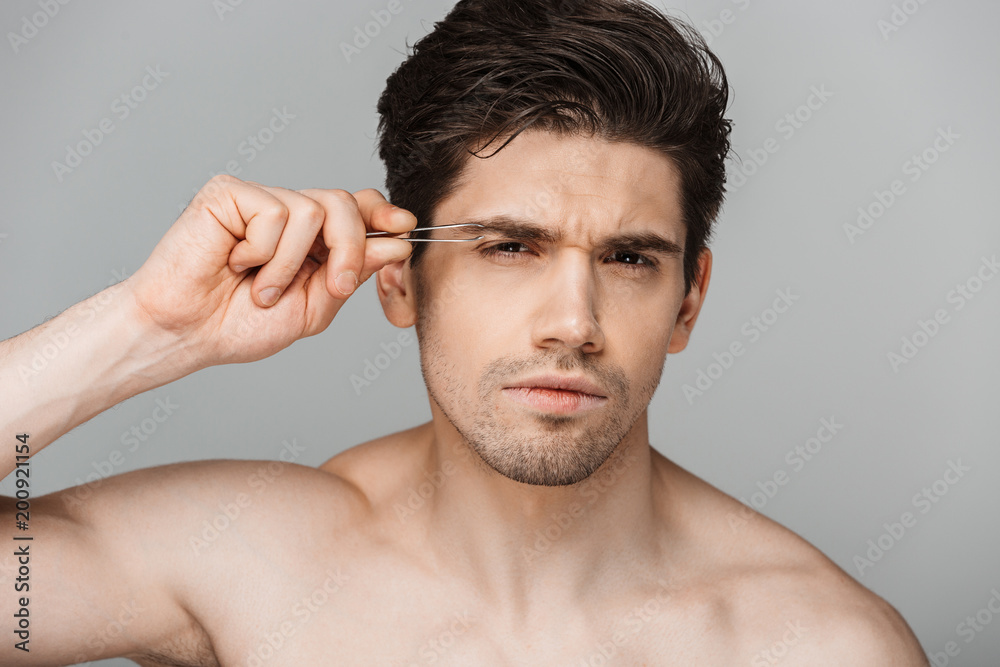 Fototapeta premium Close up beauty portrait of half naked concentrated young man